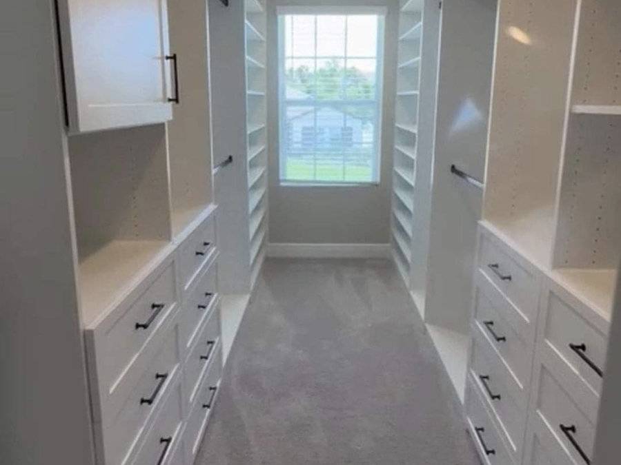 Walk-in closet with white built-in cabinetry