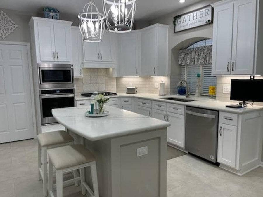 White kitchen with an island and pendant lights