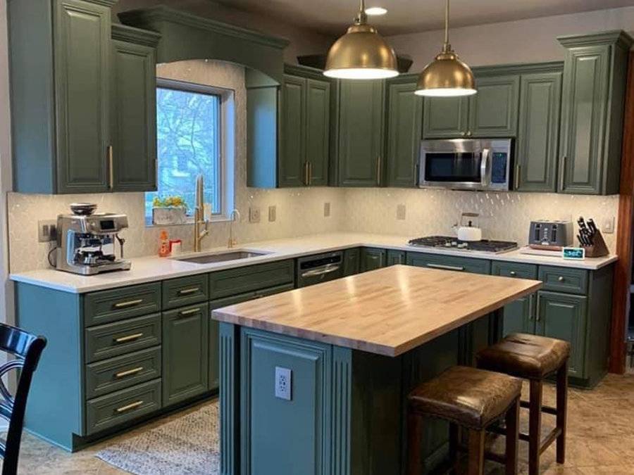 Kitchen with green cabinetry and butcher-block island