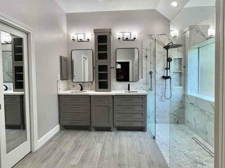 Marble bathroom with double vanity and glass shower