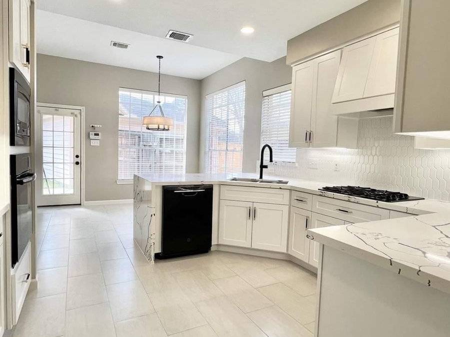 Bright kitchen build-out with stone counters