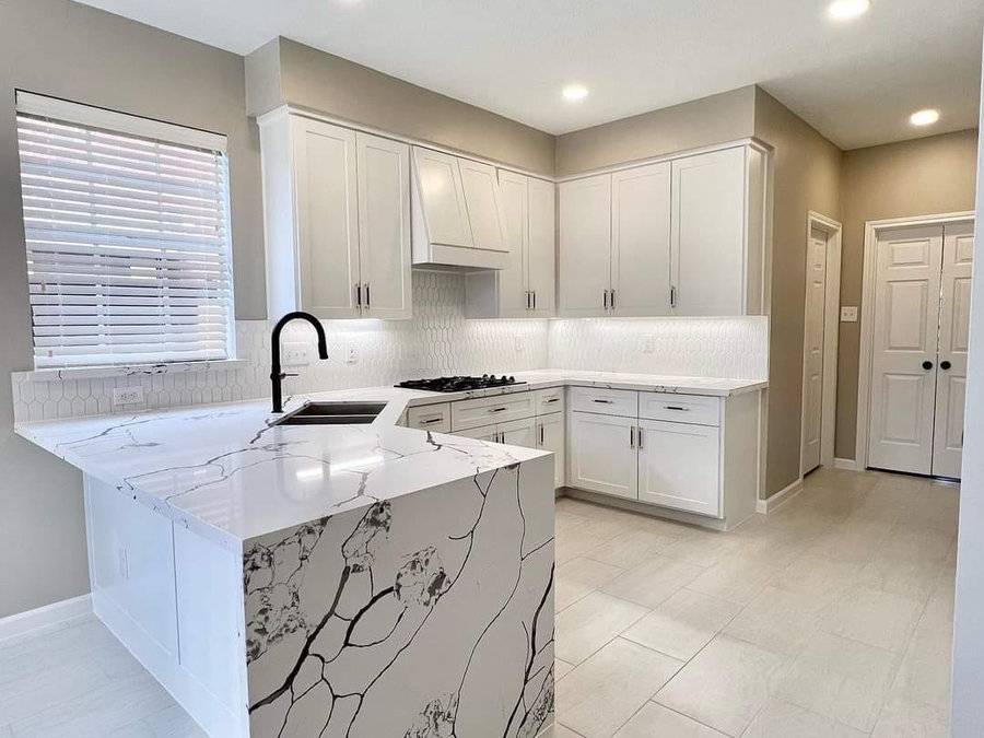 Remodelled kitchen with a marble waterfall island