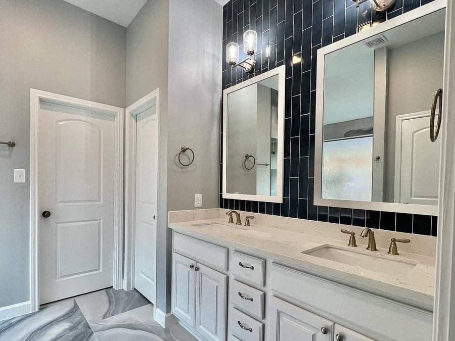 Bathroom with a dark tile accent wall