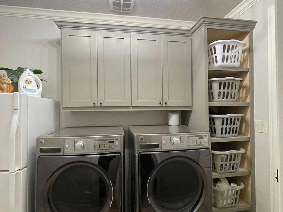 Laundry room with custom cabinetry and basket storage
